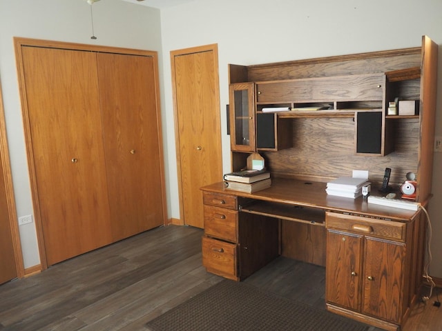 kitchen with baseboards, brown cabinets, and dark wood-style flooring