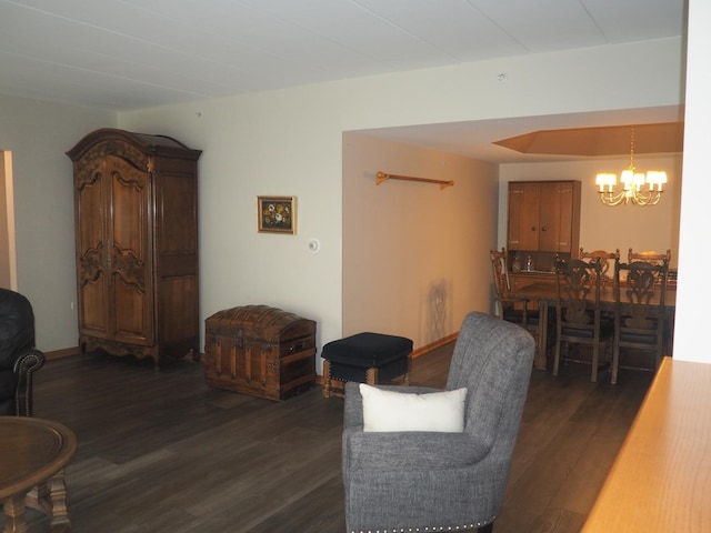 living room featuring a notable chandelier and dark wood-style flooring