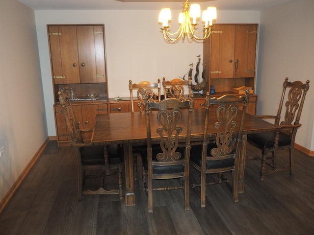 dining space featuring dark wood-style floors, baseboards, and an inviting chandelier