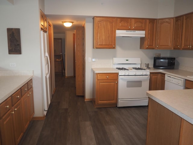 kitchen with white appliances, dark wood-style flooring, brown cabinets, and under cabinet range hood