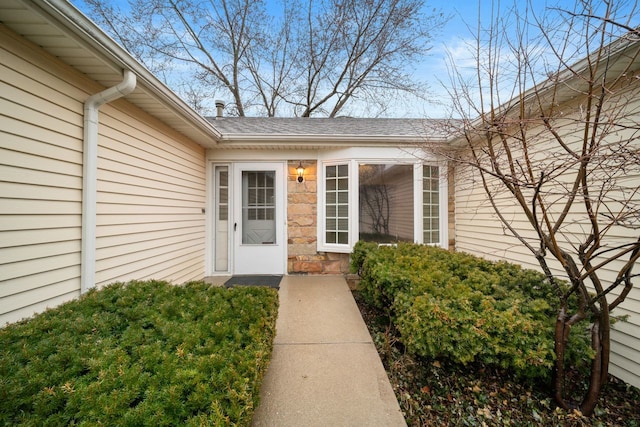 doorway to property with stone siding