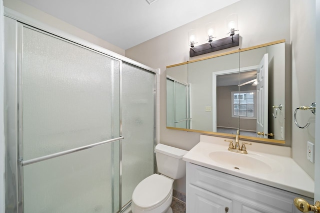 full bathroom with a shower stall, toilet, and vanity