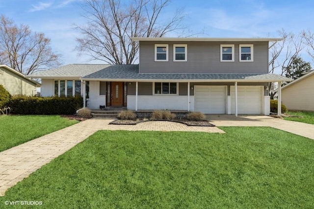 traditional-style home featuring a garage, driveway, a front lawn, and roof with shingles