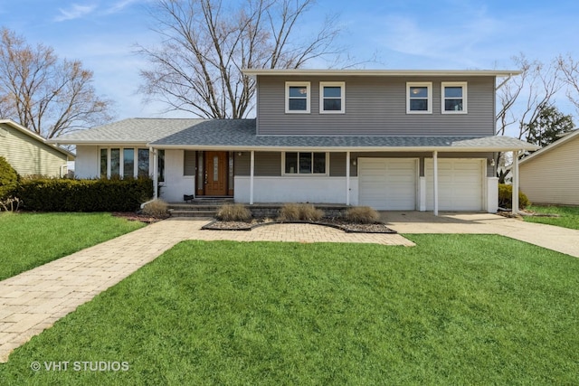 traditional-style home featuring a front yard, concrete driveway, a garage, and roof with shingles