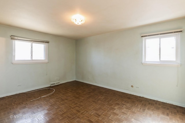 empty room featuring visible vents and baseboards