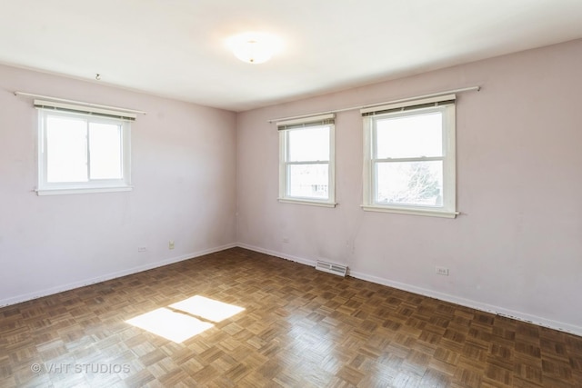 empty room featuring visible vents and baseboards