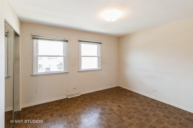 empty room featuring visible vents and baseboards