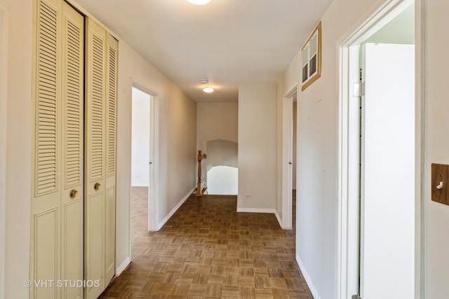 hallway featuring baseboards and visible vents