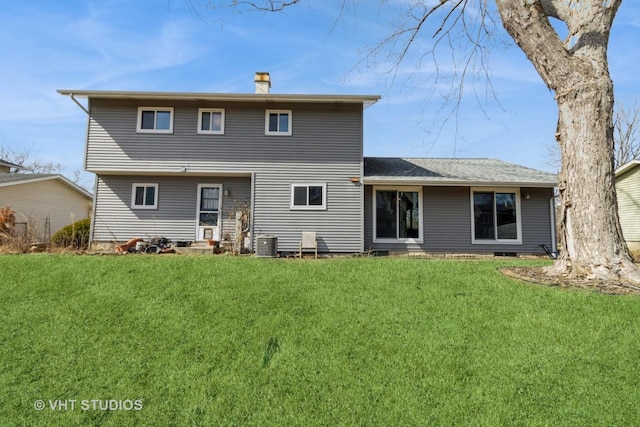 rear view of property featuring crawl space, a lawn, cooling unit, and a chimney