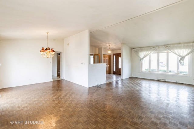 unfurnished living room featuring a chandelier and visible vents