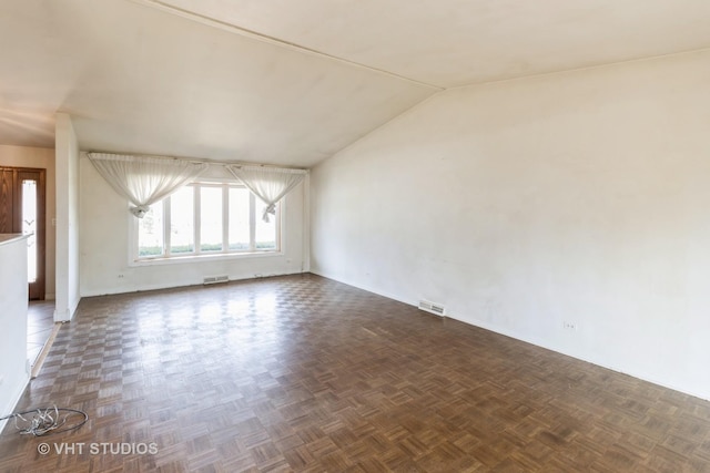 spare room with visible vents and lofted ceiling