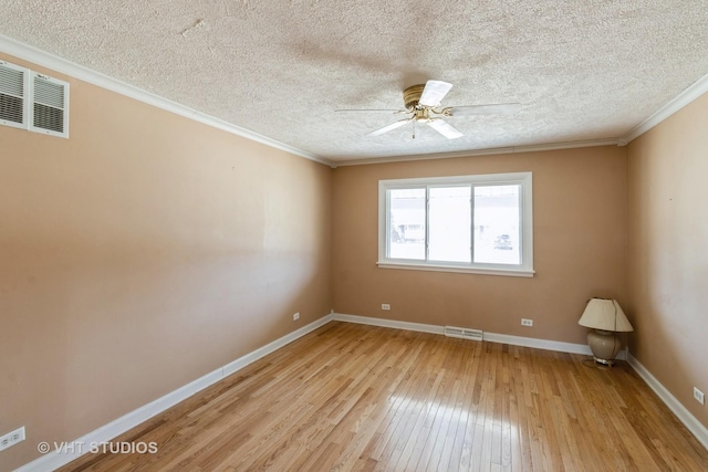 unfurnished room featuring visible vents, baseboards, ornamental molding, and light wood finished floors