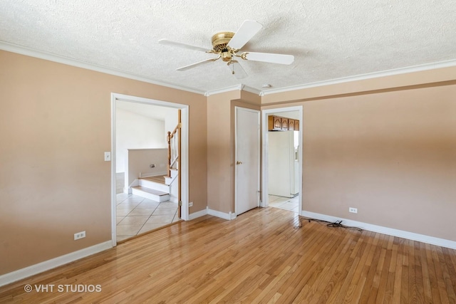 unfurnished bedroom featuring baseboards, ornamental molding, white fridge with ice dispenser, a textured ceiling, and light wood-type flooring