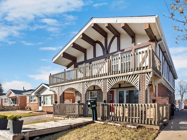 view of front of property with a balcony and brick siding