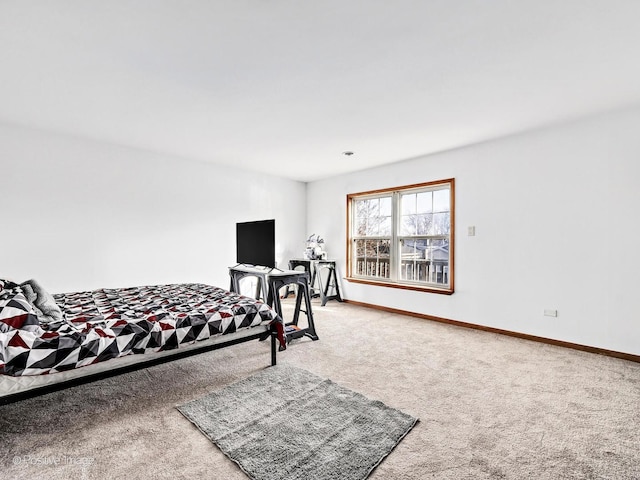 carpeted bedroom featuring baseboards