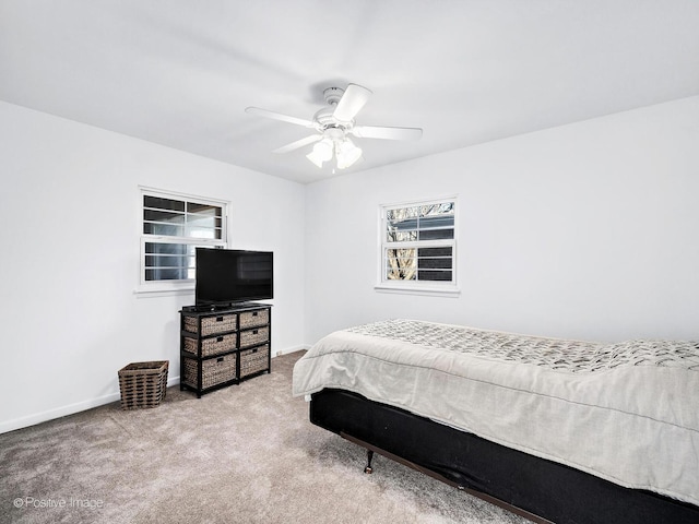 carpeted bedroom with baseboards and a ceiling fan