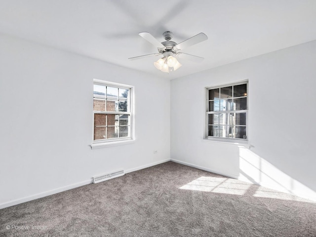 unfurnished room with baseboards, carpet, visible vents, and a ceiling fan