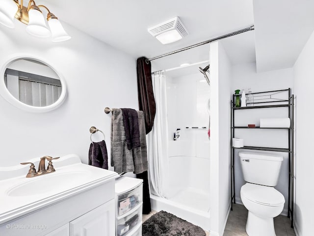 bathroom featuring visible vents, a shower stall, toilet, and vanity