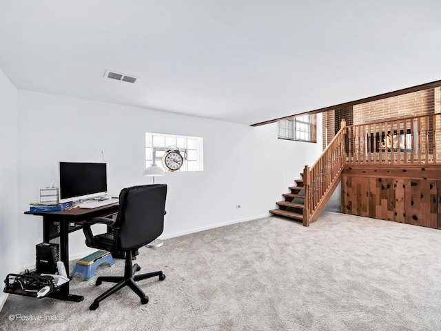 office featuring a healthy amount of sunlight, carpet floors, baseboards, and visible vents