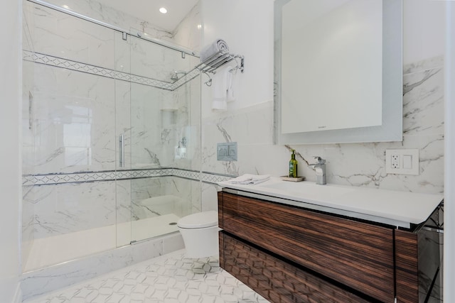 bathroom with toilet, tasteful backsplash, a marble finish shower, tile walls, and vanity