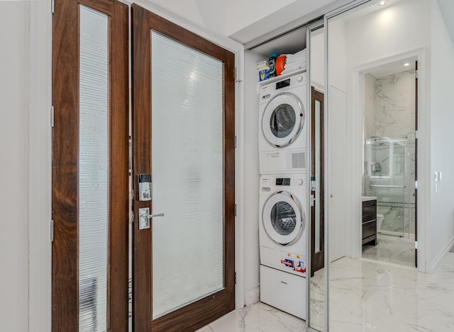 washroom with laundry area, marble finish floor, and stacked washing maching and dryer