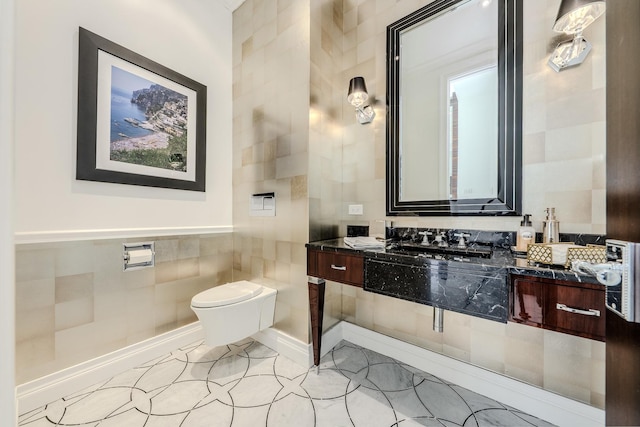 bathroom with vanity, tile walls, toilet, and tile patterned floors