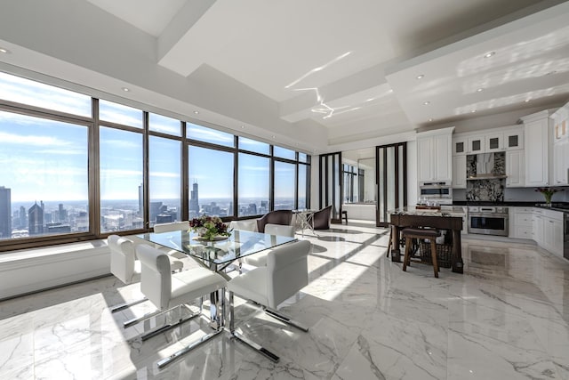 dining space featuring recessed lighting, plenty of natural light, marble finish floor, and a view of city