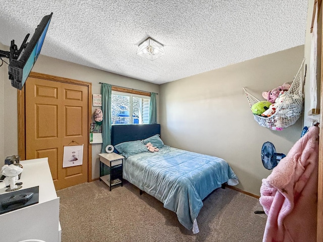 bedroom with carpet and a textured ceiling