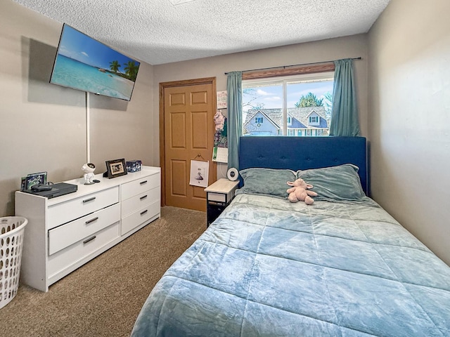 bedroom with carpet and a textured ceiling