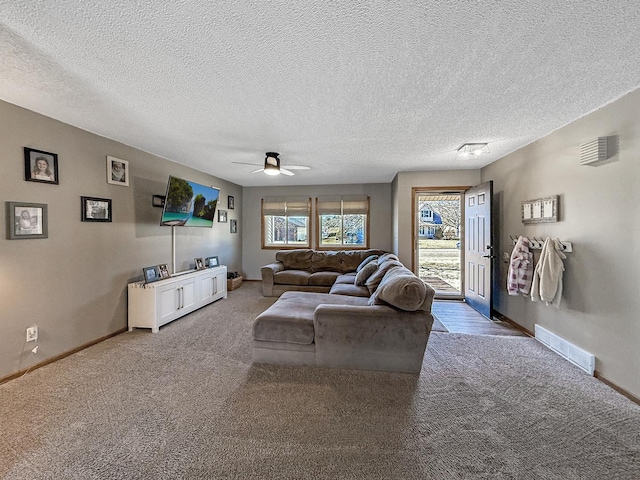 living room featuring a healthy amount of sunlight, baseboards, and visible vents