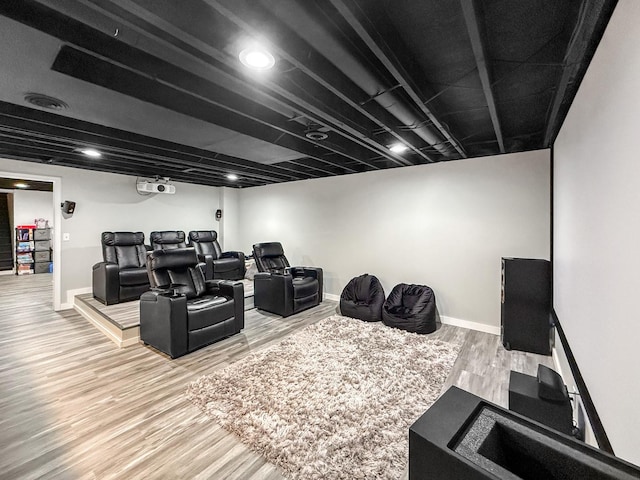 home theater with baseboards and wood finished floors