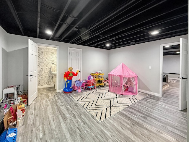 game room featuring wood finished floors and baseboards