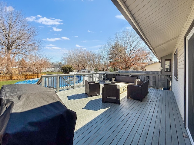 wooden deck with a swimming pool, area for grilling, fence private yard, and an outdoor living space