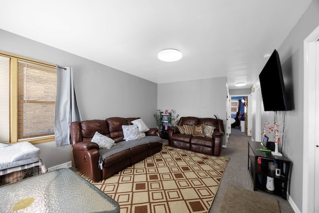 carpeted living room featuring baseboards