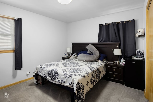 bedroom with carpet floors and baseboards