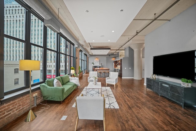 living room featuring floor to ceiling windows and wood finished floors