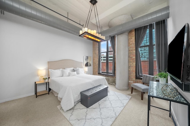 bedroom with brick wall, carpet flooring, and baseboards