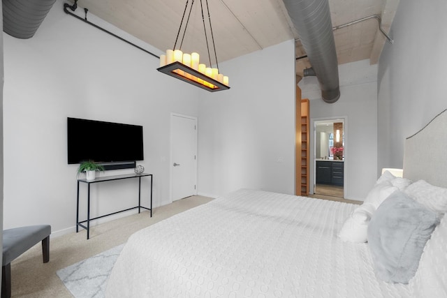 bedroom with carpet floors, a high ceiling, and baseboards