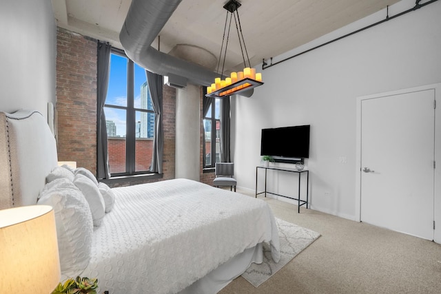 carpeted bedroom with brick wall