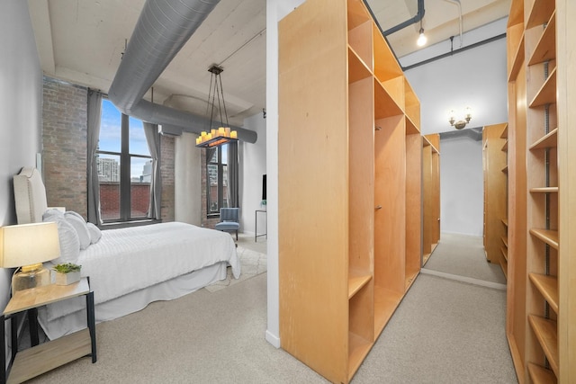 bedroom with carpet flooring and brick wall