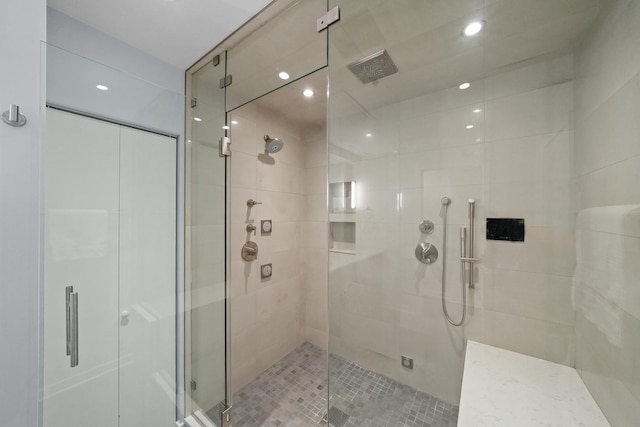 bathroom with a stall shower and recessed lighting