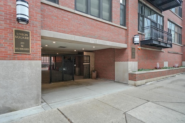 property entrance with concrete driveway and brick siding