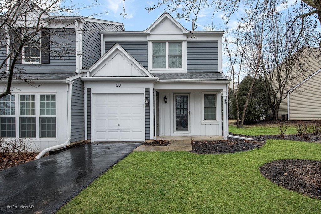 view of front facade with driveway, a garage, roof with shingles, a front lawn, and board and batten siding