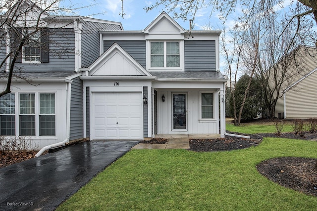 view of front facade with driveway, a garage, roof with shingles, a front lawn, and board and batten siding