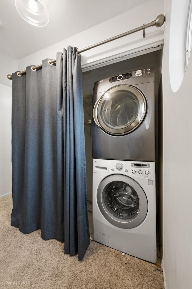 washroom with carpet floors, stacked washer and dryer, and laundry area