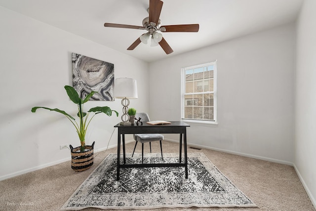 office featuring visible vents, baseboards, ceiling fan, and carpet flooring