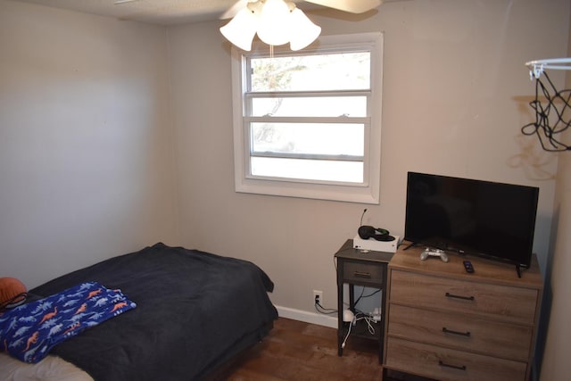 bedroom featuring ceiling fan, baseboards, and dark wood-type flooring