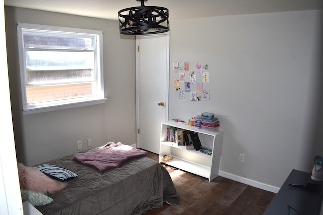 bedroom featuring dark wood-style floors and baseboards