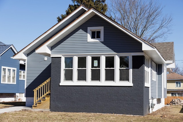 view of side of property with brick siding