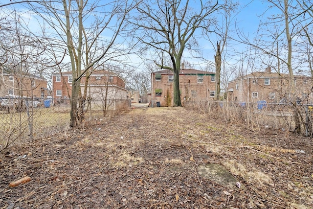 view of yard featuring a residential view and fence